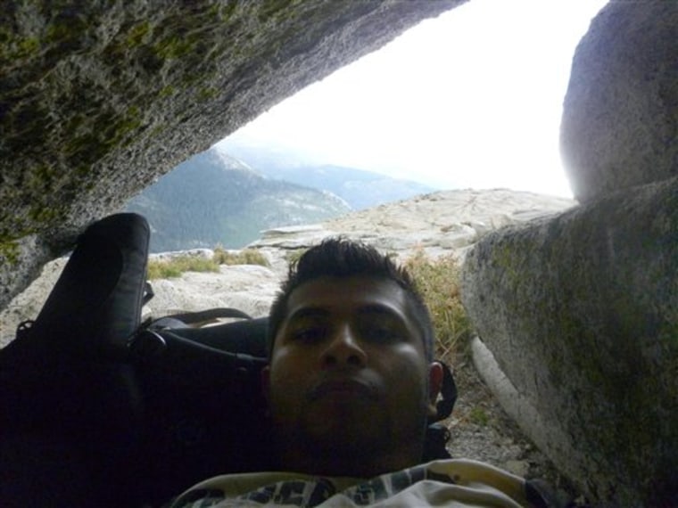 In this Sept. 24, 2011 photo provided by Armando Castillo, Castillo huddles under a rock during a storm on Half Dome in Yosemite, National Park. Castillo knew he should not attempt the last treacherous stretch up Half Dome with storm clouds looming. But he felt he had come too far not to accomplish his goal. \"About three quarters of the way up it started hailing,\" he said. \"There's a bunch of people and everybody just stops. Some women started crying because it was slippery and pretty scary. Then it cleared up.\"  While others turned back, Castillo pushed on, making him one of Yosemite National Park's worst nightmares, an increasing number of wilderness neophytes who mistakenly think the government is obligated to save them. (AP photo/Armando Castillo)